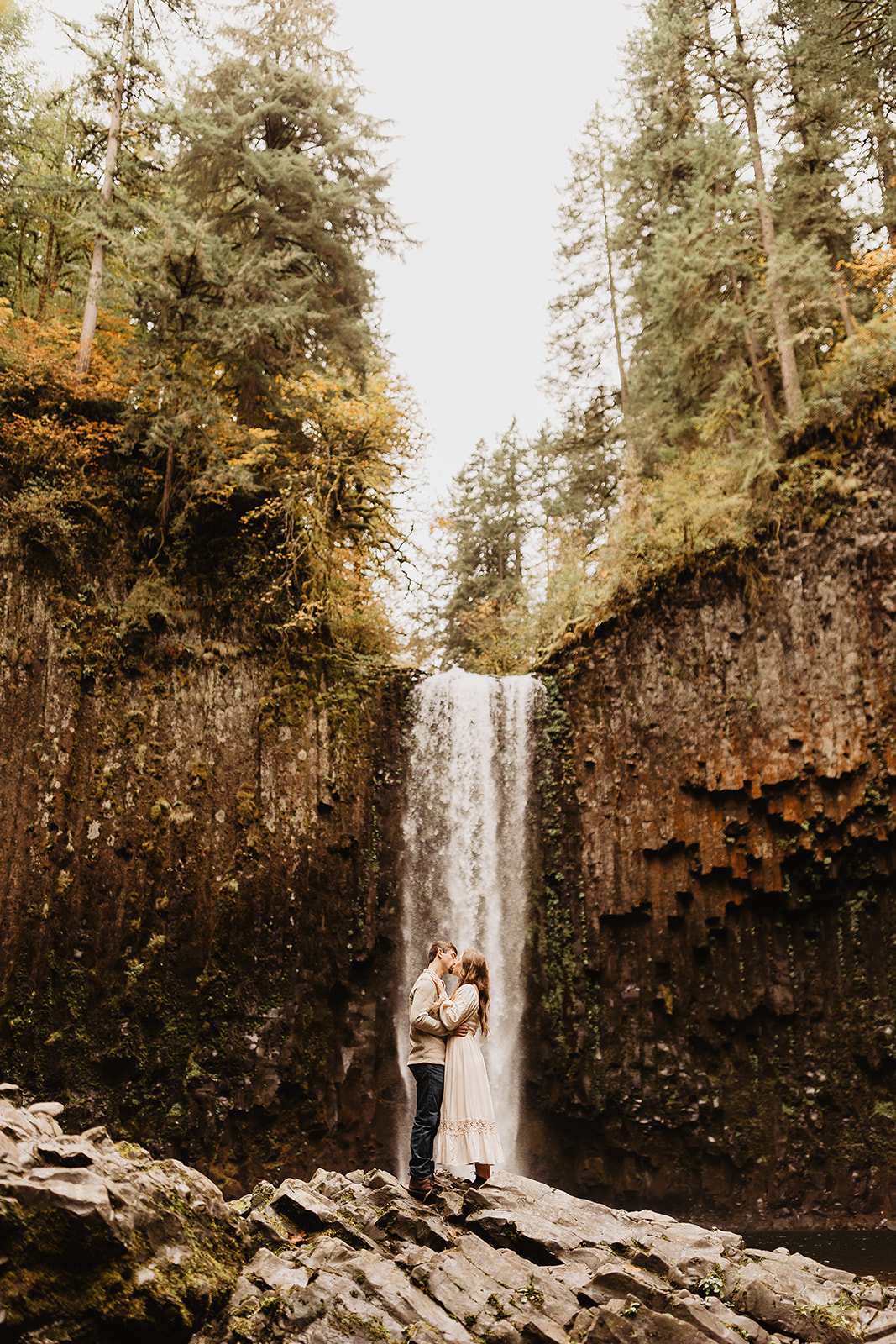 couple kissing in front of waterfall in Oregon