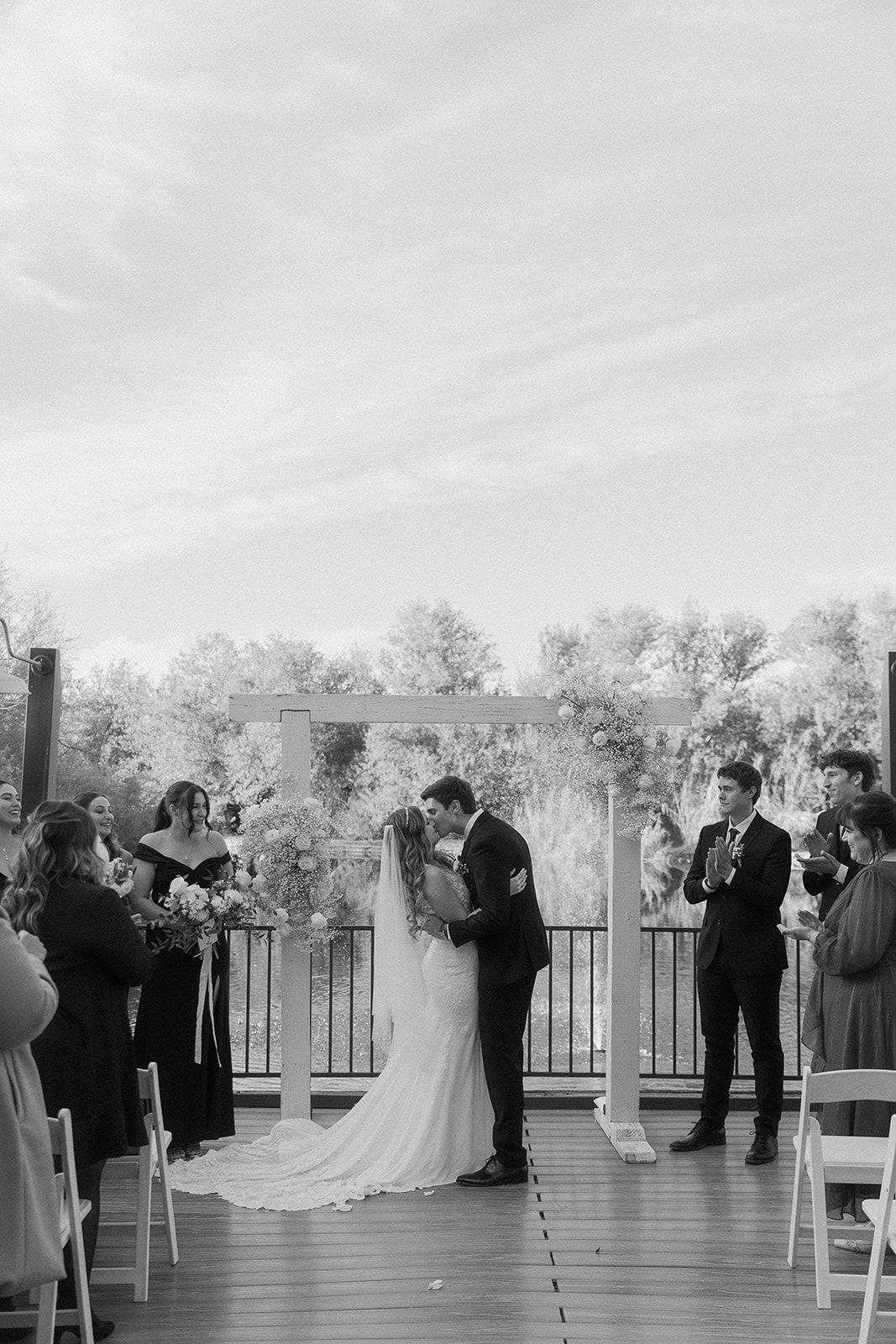 Bride and Groom First Kiss at Romantic Lakeside Wedding at Windmill Winery, Florence AZ